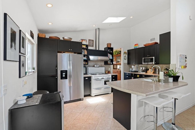 764 E Solana Cir, Solana Beach, CA 92075 - kitchen with stainless steel appliances, lofted ceiling, a skylight, a peninsula, and backsplash