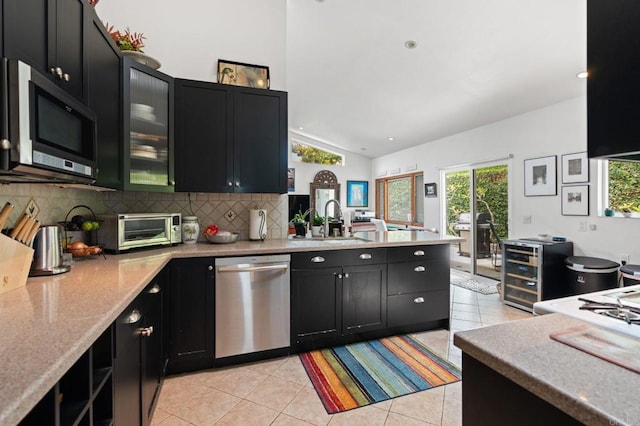 764 E Solana Cir, Solana Beach, CA 92075 - kitchen featuring stainless steel appliances, dark cabinetry, lofted ceiling, light tile patterned floors, and a peninsula