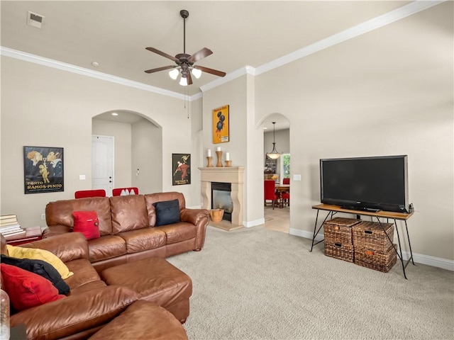 425 W Trenton Ave, Clovis, CA 93619 - living area featuring arched walkways, ceiling fan, carpet floors, crown molding, and a glass covered fireplace