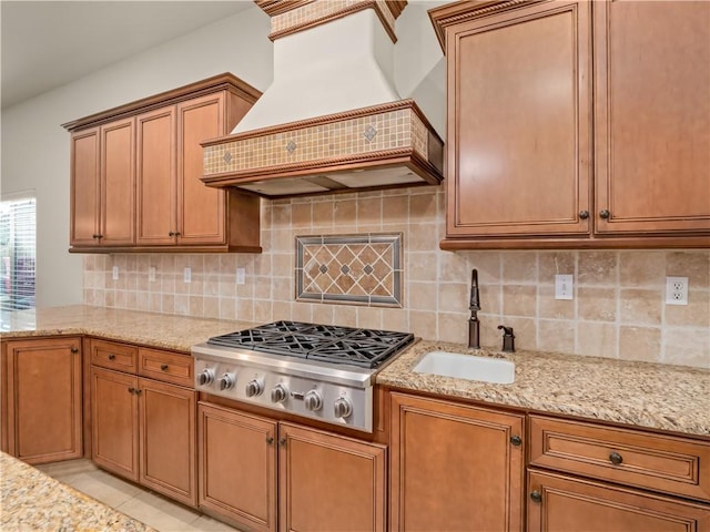 425 W Trenton Ave, Clovis, CA 93619 - kitchen featuring custom exhaust hood, stainless steel gas stovetop, light stone counters, and tasteful backsplash