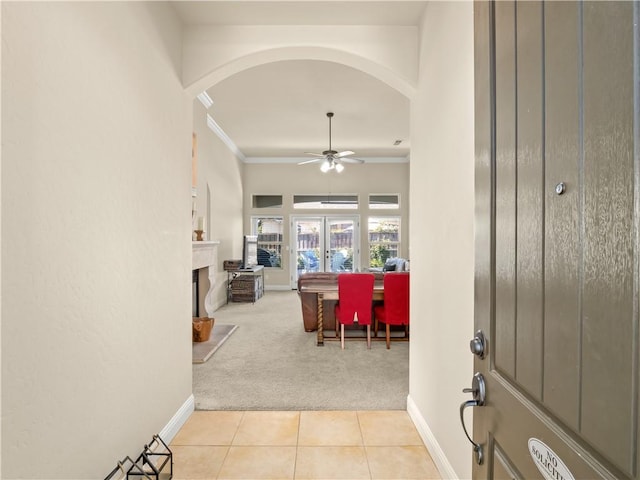 425 W Trenton Ave, Clovis, CA 93619 - tiled entryway featuring carpet, arched walkways, ceiling fan, ornamental molding, and a fireplace with raised hearth
