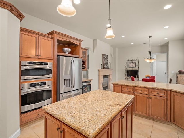 425 W Trenton Ave, Clovis, CA 93619 - kitchen with stainless steel refrigerator with ice dispenser, light tile patterned floors, a center island, brown cabinetry, and recessed lighting