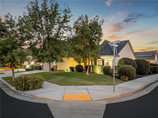 425 W Trenton Ave, Clovis, CA 93619 - view of front facade with stucco siding, a yard, concrete driveway, and an attached garage