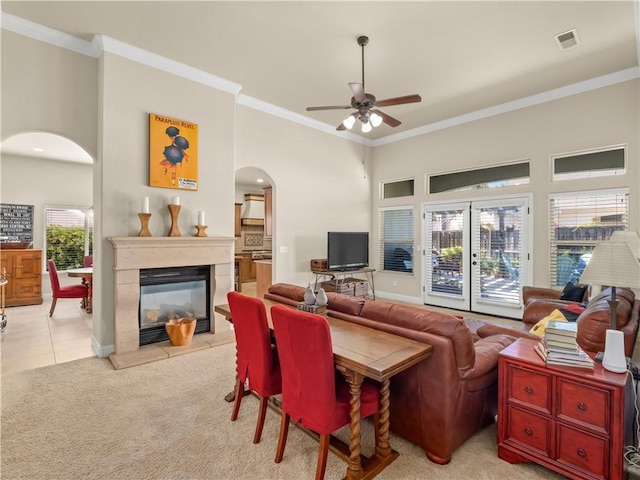 425 W Trenton Ave, Clovis, CA 93619 - living room with arched walkways, a ceiling fan, ornamental molding, a multi sided fireplace, and light carpet