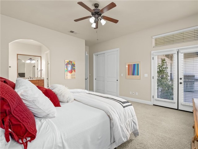 425 W Trenton Ave, Clovis, CA 93619 - bedroom with access to exterior, light colored carpet, arched walkways, ceiling fan, and ensuite bathroom