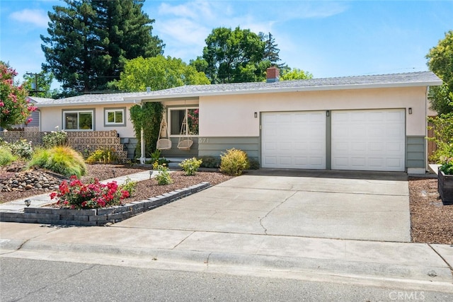 571 Redwood Way, Chico, CA 95926 - single story home featuring concrete driveway, an attached garage, stucco siding, and a chimney