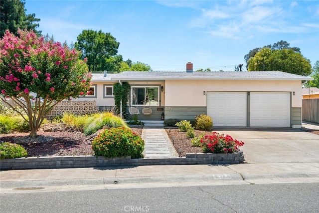 571 Redwood Way, Chico, CA 95926 - ranch-style home with a garage, driveway, and stucco siding