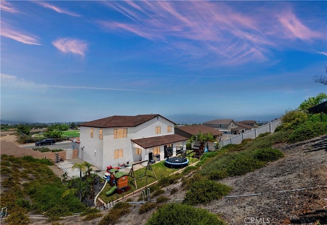 9574 Alta Cresta Ave, Riverside, CA 92508 - back of property with a trampoline and stucco siding