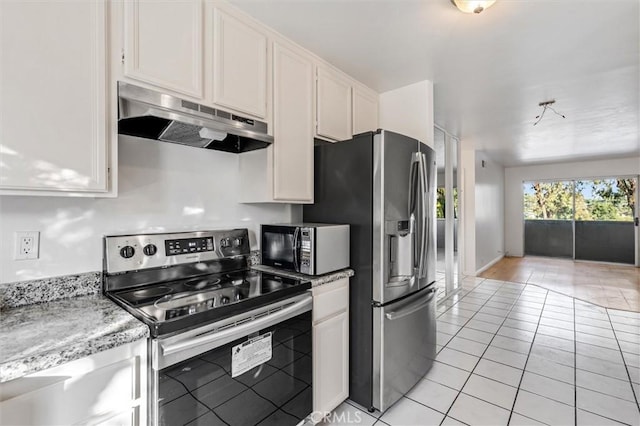 29788 Sea Shore Ln Unit 30, Laguna Niguel, CA 92677 - kitchen with appliances with stainless steel finishes, under cabinet range hood, light tile patterned floors, white cabinetry, and light stone counters