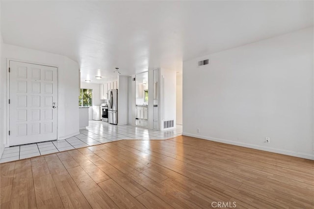 29788 Sea Shore Ln Unit 30, Laguna Niguel, CA 92677 - unfurnished living room featuring light wood-style floors and baseboards