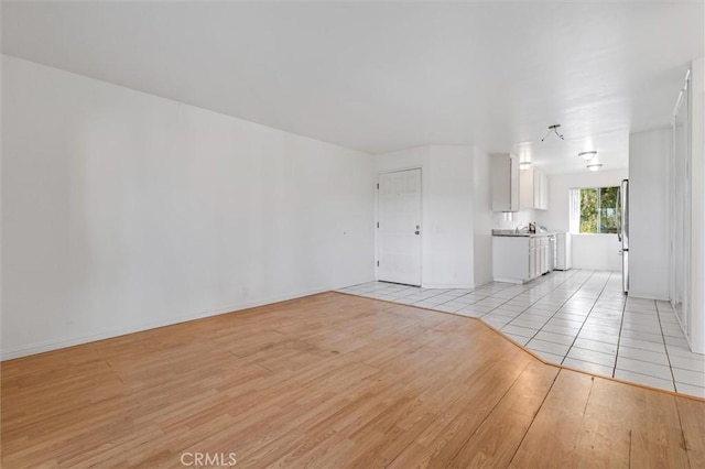 29788 Sea Shore Ln Unit 30, Laguna Niguel, CA 92677 - unfurnished living room with light wood-style flooring and baseboards