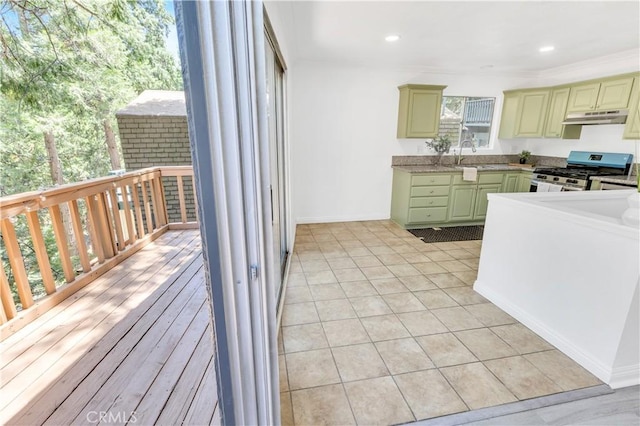 26188 Boulder Ln, Twin Peaks, CA 92391 - kitchen with stainless steel gas range oven, under cabinet range hood, green cabinets, cream cabinetry, and recessed lighting