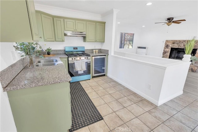 26188 Boulder Ln, Twin Peaks, CA 92391 - kitchen with gas stove, under cabinet range hood, green cabinetry, light tile patterned floors, and a ceiling fan