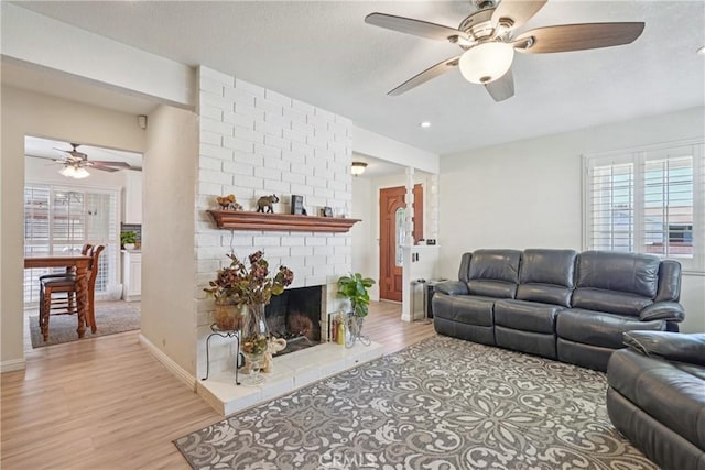 3126 E Merrygrove St, West Covina, CA 91792 - living room with ceiling fan, light wood-type flooring, a brick fireplace, and recessed lighting