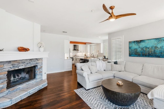 3131 Ferncreek Ln, Escondido, CA 92027 - living room with dark wood finished floors, a ceiling fan, and a stone fireplace