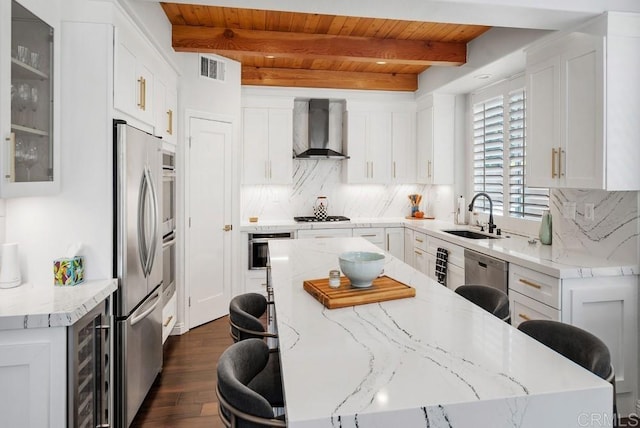 3131 Ferncreek Ln, Escondido, CA 92027 - kitchen featuring wall chimney range hood, a wooden ceiling with exposed beams, appliances with stainless steel finishes, wine cooler, and a kitchen island
