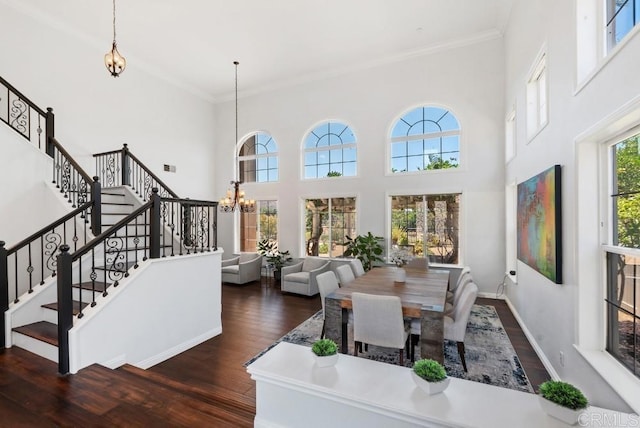 3131 Ferncreek Ln, Escondido, CA 92027 - dining room featuring wood finished floors, a chandelier, stairs, crown molding, and a towering ceiling