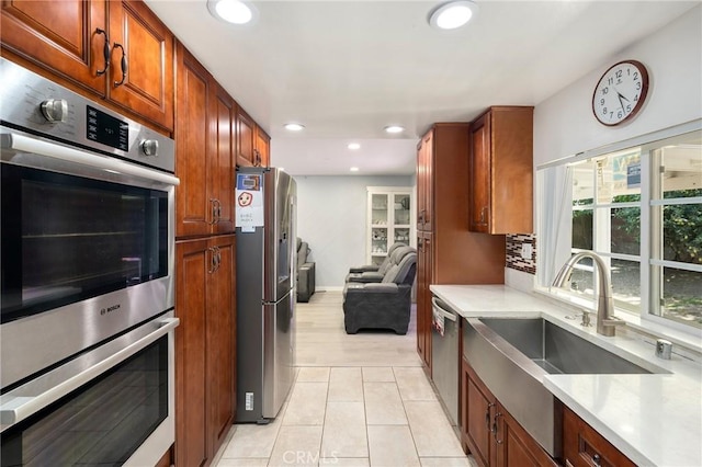 8303 Topeka Dr, Northridge, CA 91324 - kitchen with appliances with stainless steel finishes, light countertops, recessed lighting, light tile patterned flooring, and open floor plan