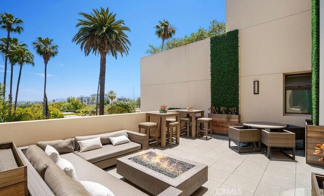 447 N Doheny Dr Unit 104, Beverly Hills, CA 90210 - view of patio with an outdoor living space with a fire pit and outdoor dining area