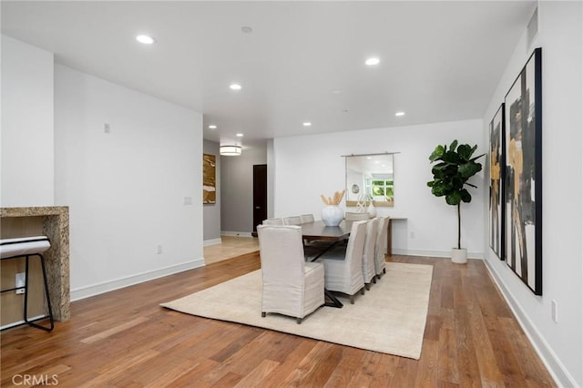 447 N Doheny Dr Unit 104, Beverly Hills, CA 90210 - dining area featuring wood finished floors and recessed lighting