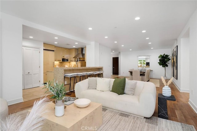 447 N Doheny Dr Unit 104, Beverly Hills, CA 90210 - living room with light wood finished floors and recessed lighting