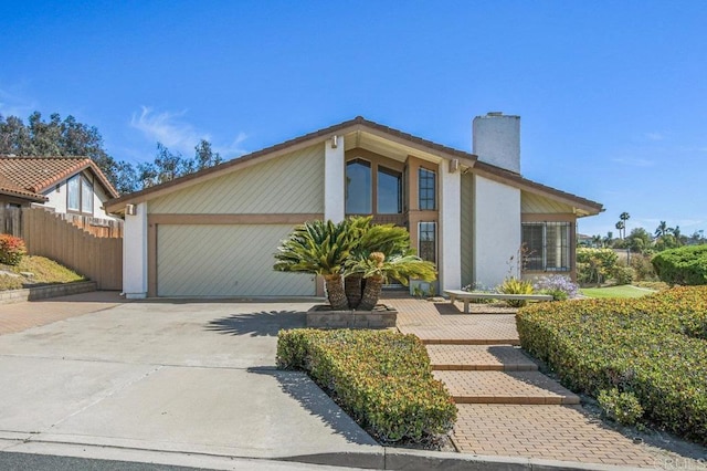 5420 Mirar Ct, Bonita, CA 91902 - mid-century inspired home with driveway, an attached garage, a chimney, and stucco siding