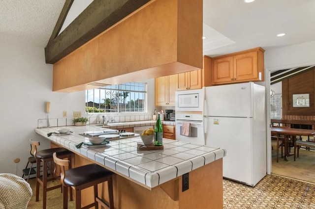 5420 Mirar Ct, Bonita, CA 91902 - kitchen featuring white appliances, tile counters, a peninsula, a kitchen breakfast bar, and recessed lighting