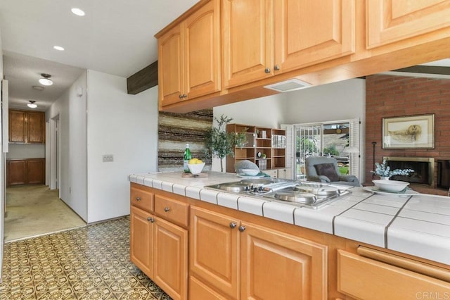 5420 Mirar Ct, Bonita, CA 91902 - kitchen featuring stovetop, tile counters, a fireplace, light flooring, and recessed lighting