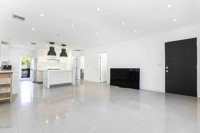 10609 Fernglen Ave, Tujunga, CA 91042 - unfurnished living room with light tile patterned floors and recessed lighting