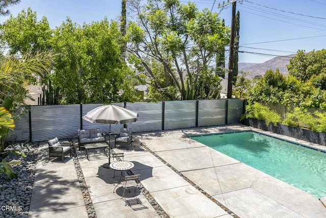 10609 Fernglen Ave, Tujunga, CA 91042 - view of pool featuring a patio area, a fenced backyard, a mountain view, and an outdoor hangout area