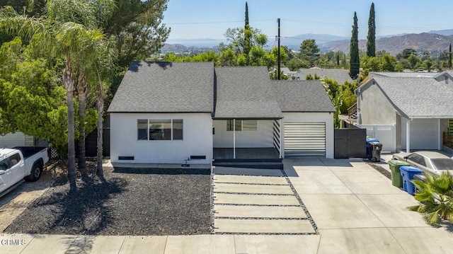 10609 Fernglen Ave, Tujunga, CA 91042 - view of front facade featuring a mountain view, roof with shingles, and stucco siding