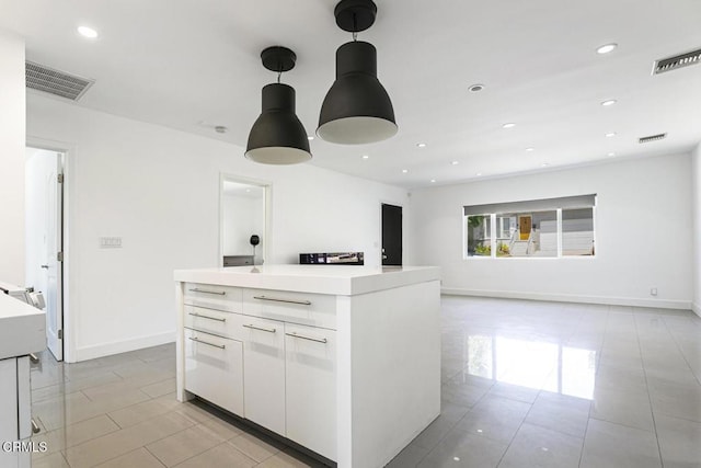 10609 Fernglen Ave, Tujunga, CA 91042 - kitchen featuring white cabinetry, light countertops, light tile patterned floors, pendant lighting, and recessed lighting