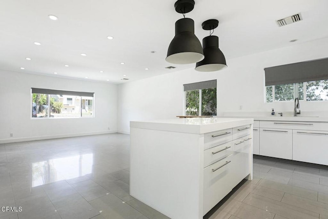 10609 Fernglen Ave, Tujunga, CA 91042 - kitchen with plenty of natural light, light tile patterned floors, recessed lighting, white cabinets, and light countertops