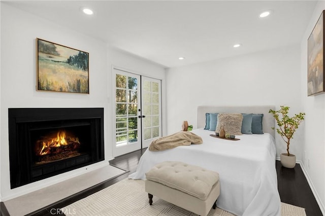 11601 Montana Ave Unit 7, Los Angeles, CA 90049 - bedroom with access to exterior, wood finished floors, recessed lighting, and a warm lit fireplace