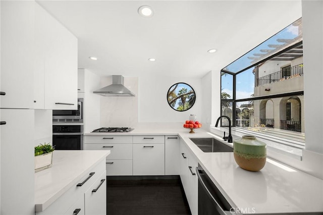 11601 Montana Ave Unit 7, Los Angeles, CA 90049 - kitchen featuring wall chimney exhaust hood, appliances with stainless steel finishes, white cabinets, light countertops, and recessed lighting