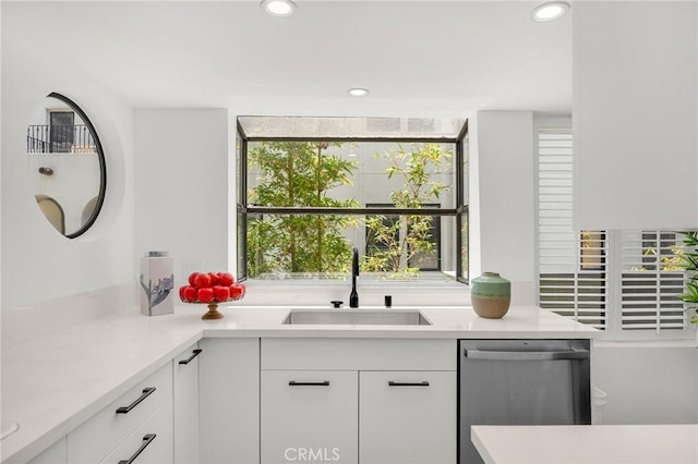 11601 Montana Ave Unit 7, Los Angeles, CA 90049 - kitchen with stainless steel dishwasher, light countertops, white cabinetry, and recessed lighting