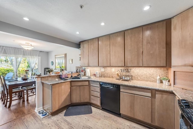 4843 Flying Cloud Way, Carlsbad, CA 92008 - kitchen with black dishwasher, a peninsula, light wood-style floors, stove, and backsplash