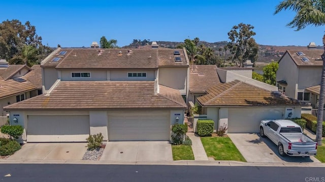4843 Flying Cloud Way, Carlsbad, CA 92008 - view of front of home with a tile roof, stucco siding, concrete driveway, and a garage