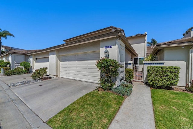 4843 Flying Cloud Way, Carlsbad, CA 92008 - view of front of property featuring driveway, stucco siding, an attached garage, a gate, and a front lawn