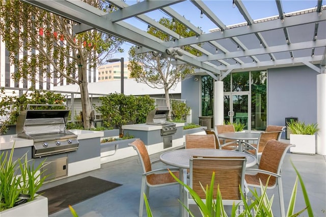 411 W Seaside Way Unit 402, Long Beach, CA 90802 - view of patio featuring an outdoor kitchen, outdoor dining area, and a pergola