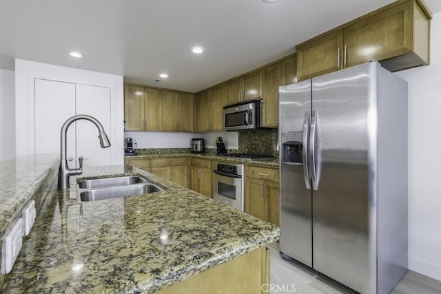 411 W Seaside Way Unit 402, Long Beach, CA 90802 - kitchen featuring stainless steel appliances, brown cabinetry, light stone counters, and recessed lighting