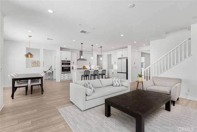 32886 Birchall Ct, Winchester, CA 92596 - living area featuring light wood finished floors, recessed lighting, and stairway