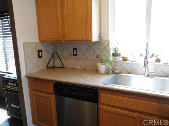 1203 Buckwheat Trl, Campo, CA 91906 - kitchen featuring dishwasher, decorative backsplash, light countertops, and brown cabinets