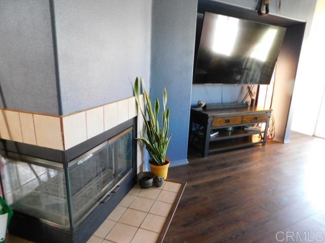 1203 Buckwheat Trl, Campo, CA 91906 - living room with wood finished floors and a fireplace