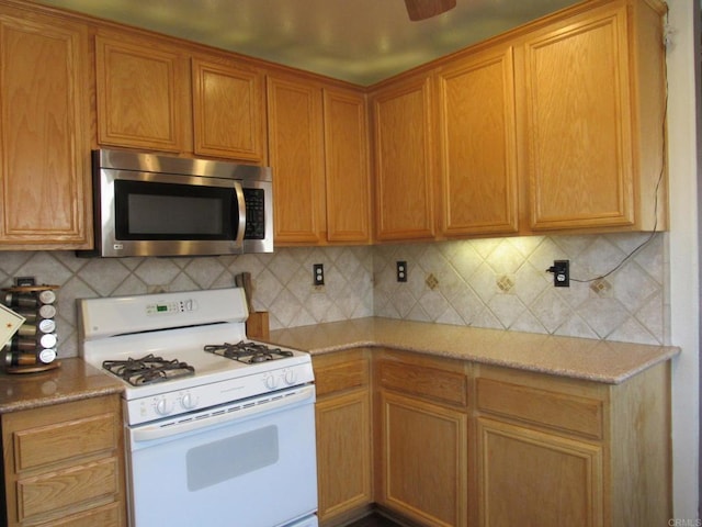 1203 Buckwheat Trl, Campo, CA 91906 - kitchen featuring gas range gas stove, stainless steel microwave, and decorative backsplash