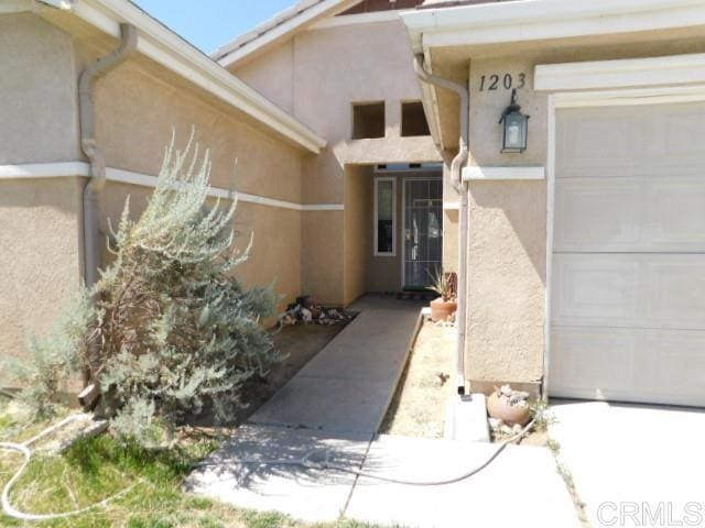 1203 Buckwheat Trl, Campo, CA 91906 - doorway to property featuring stucco siding and an attached garage