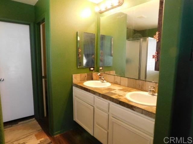 1203 Buckwheat Trl, Campo, CA 91906 - bathroom with double vanity, an enclosed shower, and wood finished floors