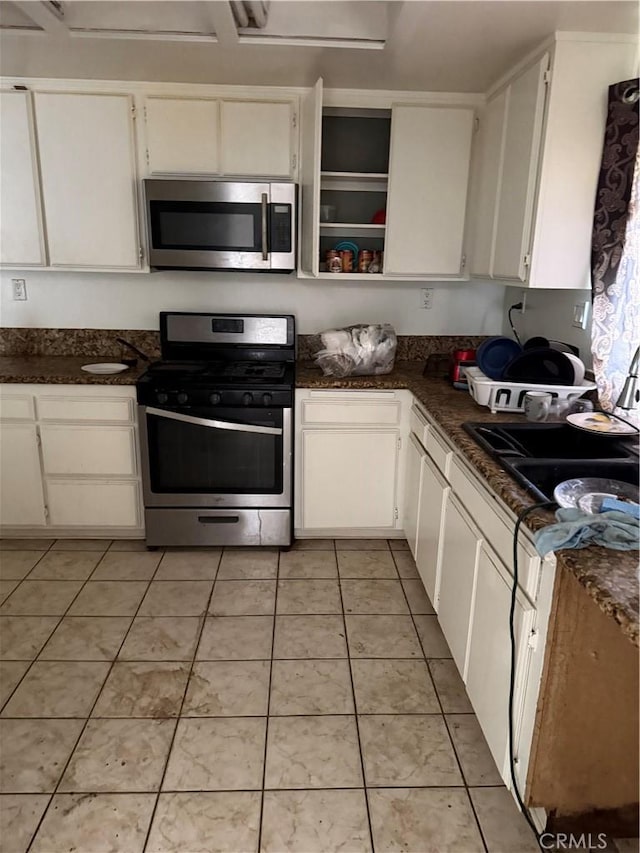 41111 172nd St E, Lancaster, CA 93535 - kitchen featuring stainless steel appliances, white cabinetry, light tile patterned floors, and open shelves