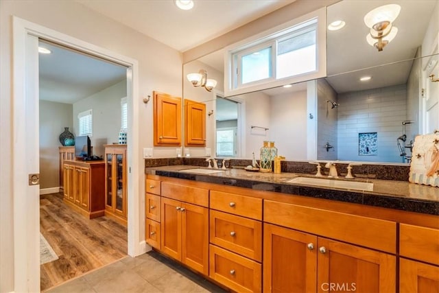 923 Farroll Ave, Arroyo Grande, CA 93420 - bathroom featuring double vanity, a tile shower, healthy amount of natural light, and tile patterned floors