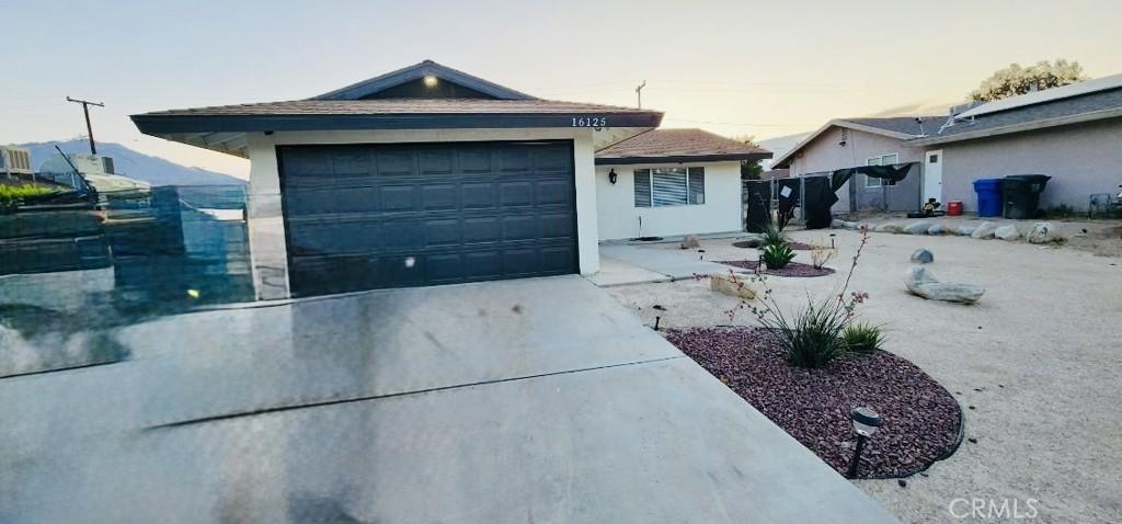 16125 Via Vis, Desert Hot Springs, CA 92240 - single story home featuring concrete driveway, an attached garage, and stucco siding